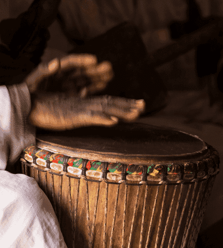 drummer playing on djembe drum along with west-africa and malinke rhythms