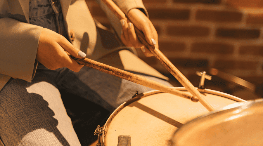 Female drummer playing bossa nova and samba music on drum set